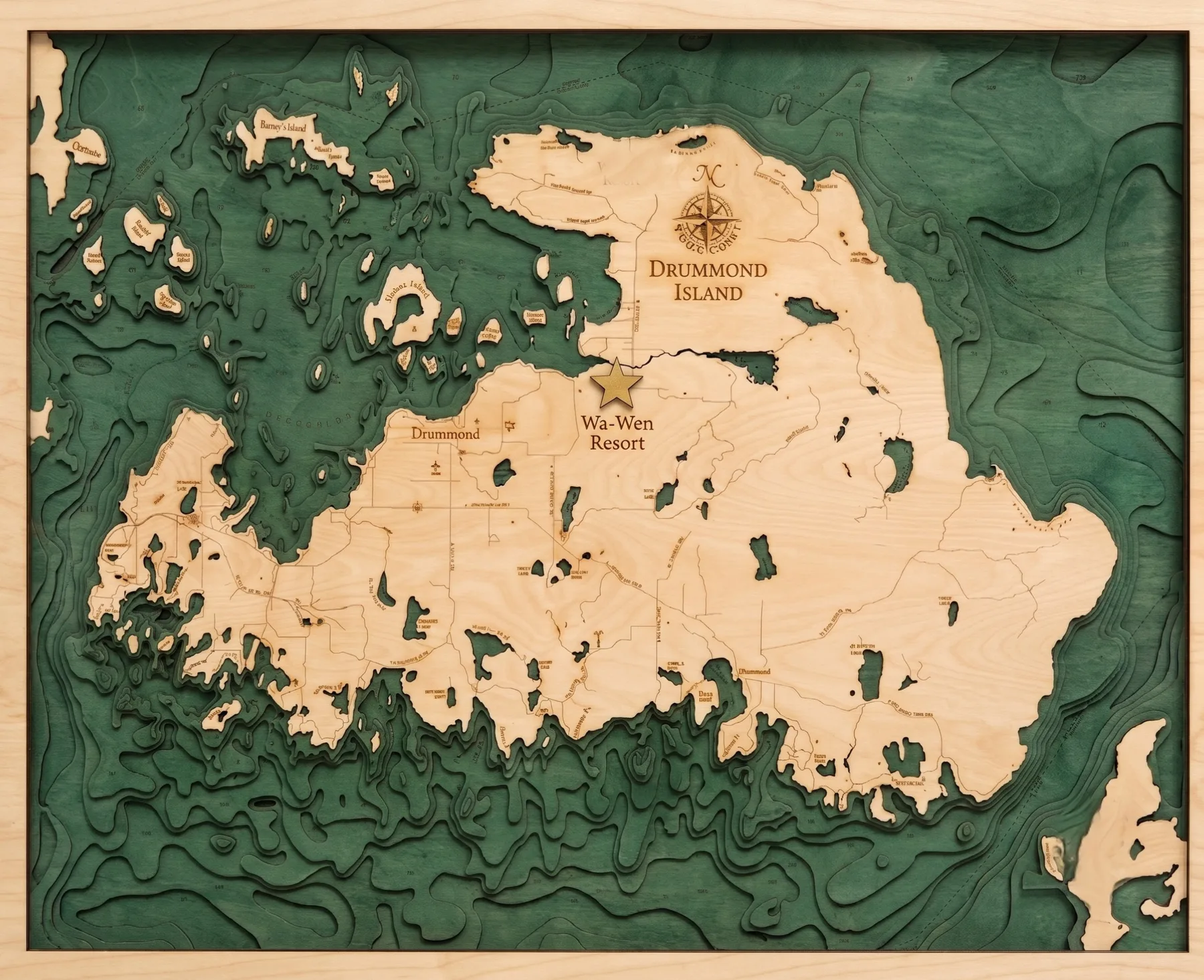 Illustrated wood-carved map of Drummond Island showing Wa-Wen Resort on Maxton Bay